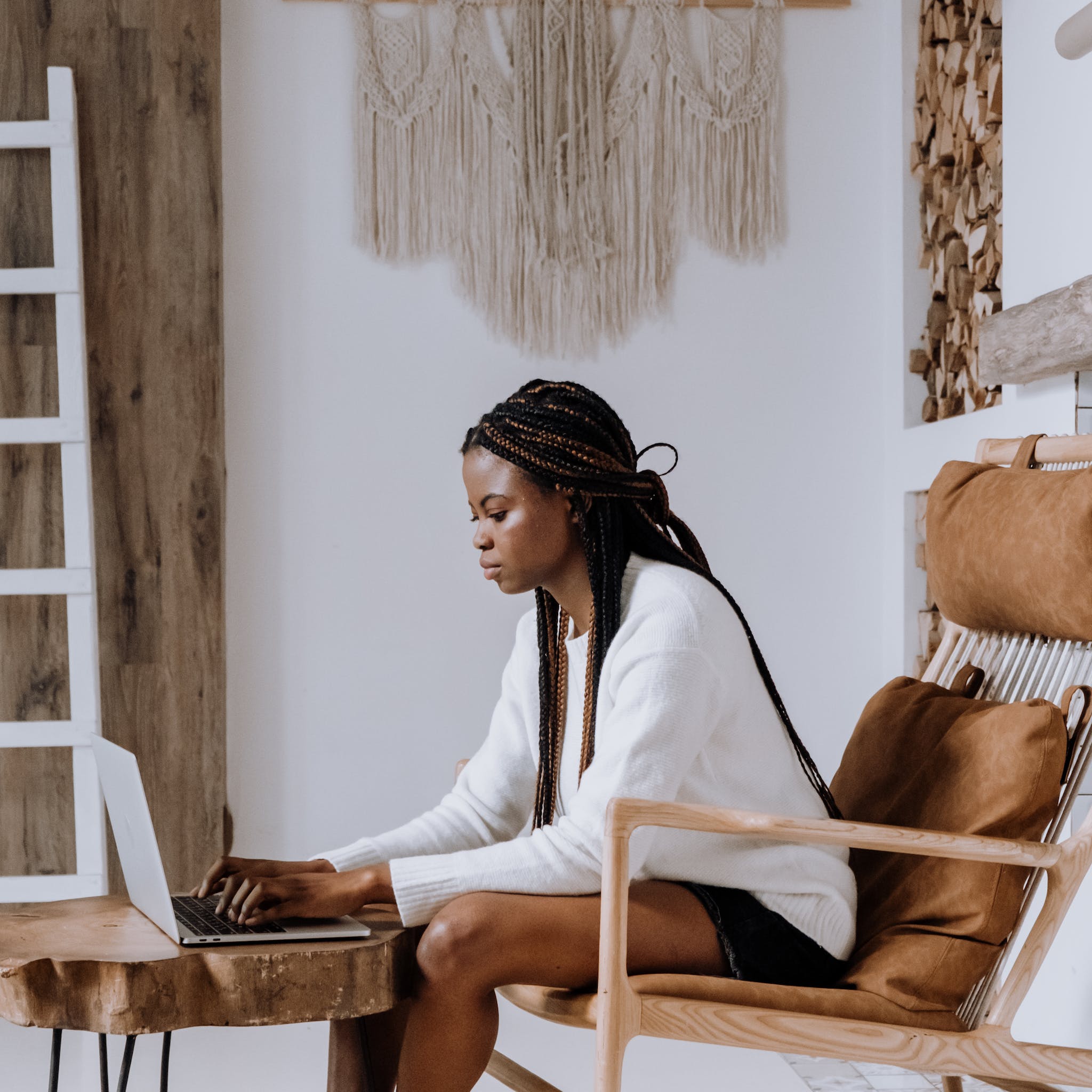 Woman in White Long Sleeve Shirt Sitting on Brown Wooden Chair